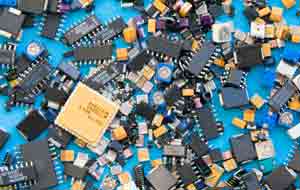 A selection of surface mount components including SMD capacitors, SMD resistors, integrated circuits, etc